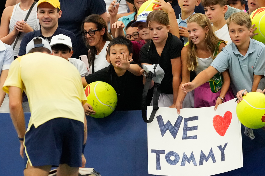 Spectators ask for autographs from Tommy Paul, of the United States, after he defeated Coleman Wong, of Hong Kong, during the first round of the U.S. Open tennis championships Sunday, Aug. 30, 2026, in New York. (AP Photo/Yuki Iwamura)