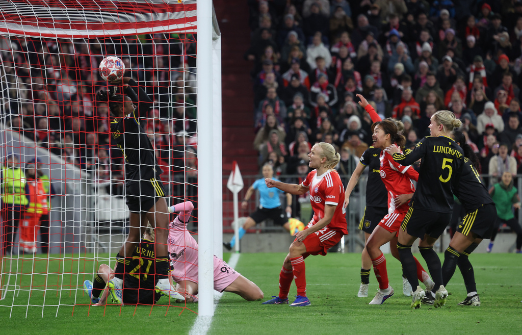 The ball lands behin Manchester United's goalkeeper Phallon Tullis-Joyce bottom left to make it 1-1 during the Women's Champions League quarterfinal second leg soccer match between Bayern Munich and Manchester United in Munich, Germany, Wednesday, April 1, 2026. (Karl-Josef Hildenbrand/dpa via AP)
