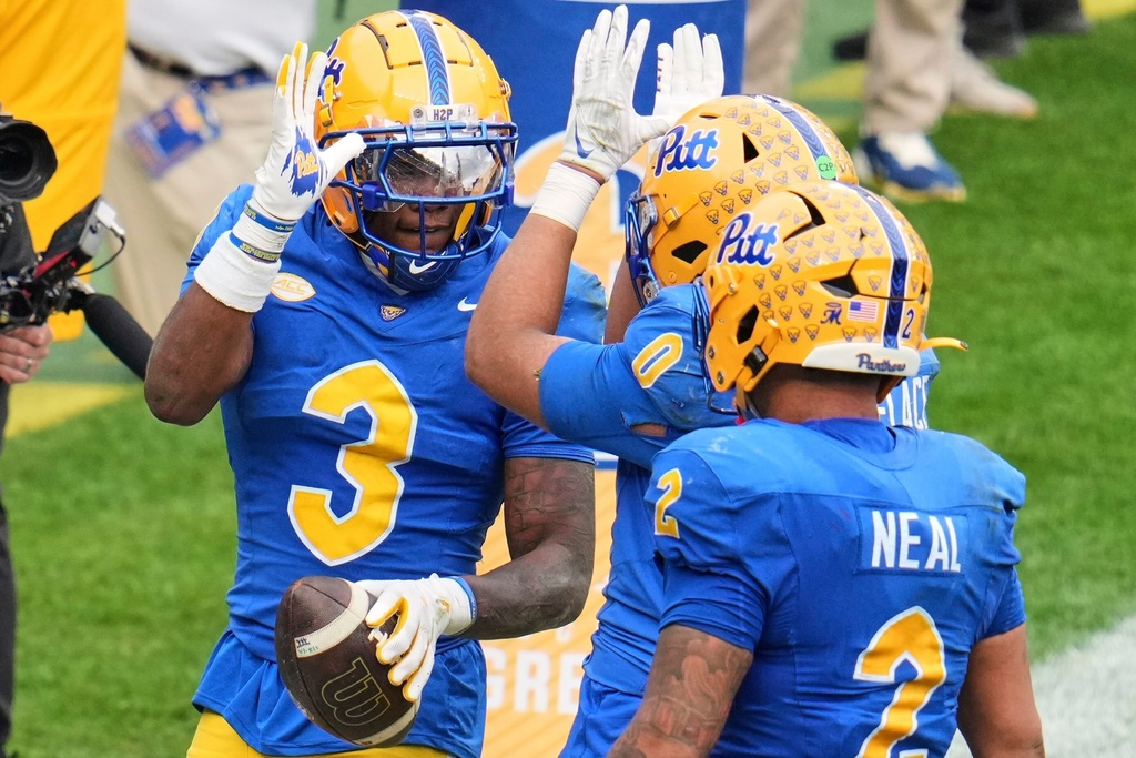 Pittsburgh linebacker Rasheem Biles (3) celebrates with linebacker Braylan Lovelace (0) after returning an interception for a touchdown during the second half of an NCAA college football game against Notre Dame in Pittsburgh, Saturday, Nov. 15, 2025. (AP Photo/Gene J. Puskar)