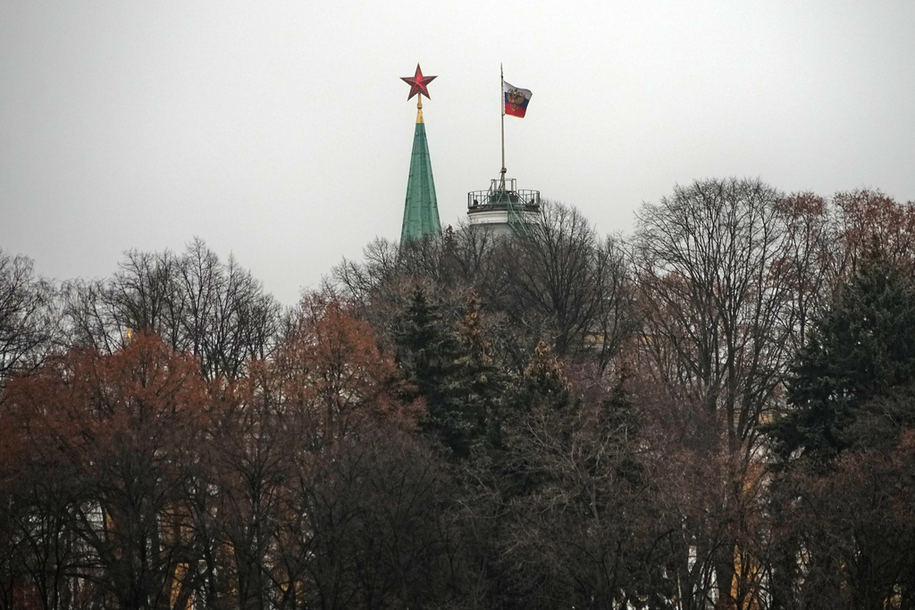 A red star atop of the Spasskaya Tower, left, and a Presidential Standard atop of the Senate Palace in the Moscow Kremlin, in Moscow, Tuesday, Dec. 2, 2025. (AP Photo/Alexander Zemlianichenko)