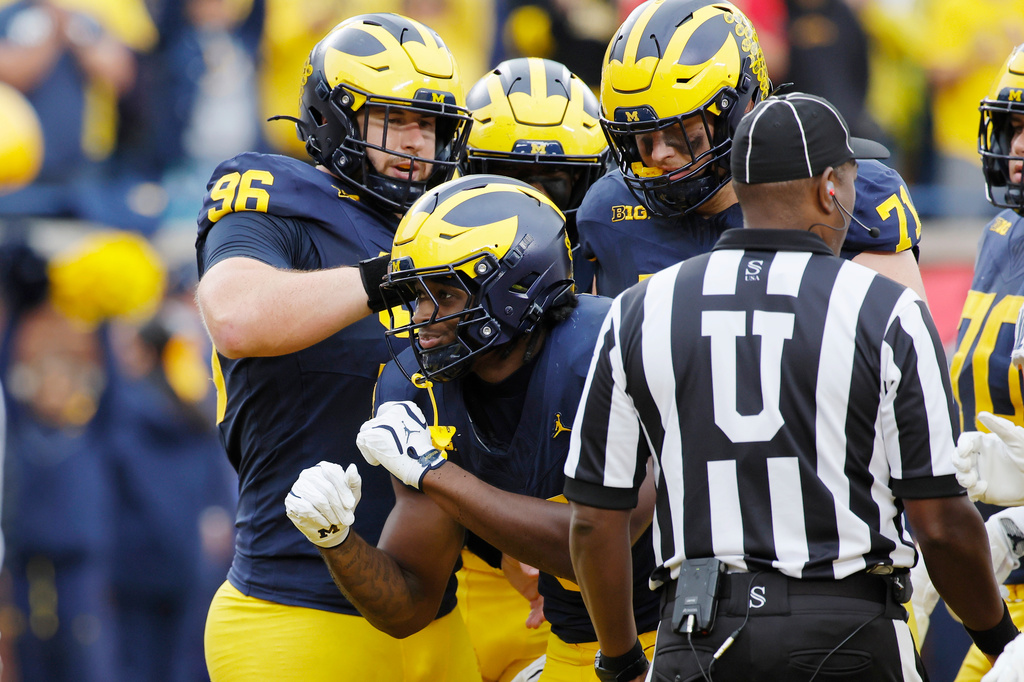 Michigan running back Savion Hiter (5) celebrates with offensive lineman Manuel Beigel (96) after scoring a touchdown against UTEP during the first half of an NCAA college football game Saturday, Sept. 19, 2026, in Ann Arbor, Mich. (AP Photo/Duane Burleson)