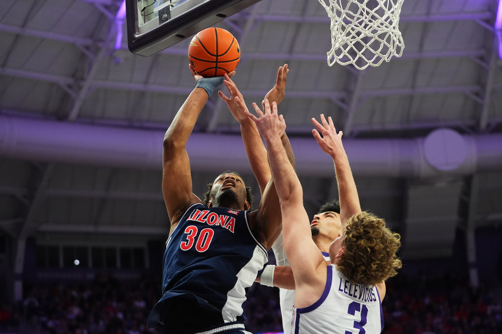 Arizona forward Tobe Awaka (30) shoots against TCU defenders Liutauras Lelevicius (3) and David Punch, center, during the first half of an NCAA college basketball game Saturday, Jan. 10, 2026, in Fort Worth, Texas. (AP Photo/LM Otero)