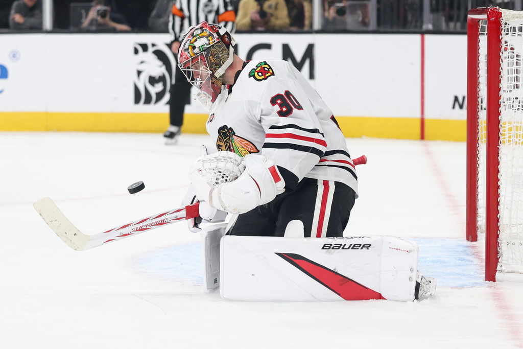 Chicago Blackhawks goaltender Spencer Knight (30) makes a save against the Vegas Golden Knights during the second period of an NHL hockey game Tuesday, Dec. 2, 2025, in Las Vegas. (AP Photo/Ian Maule)