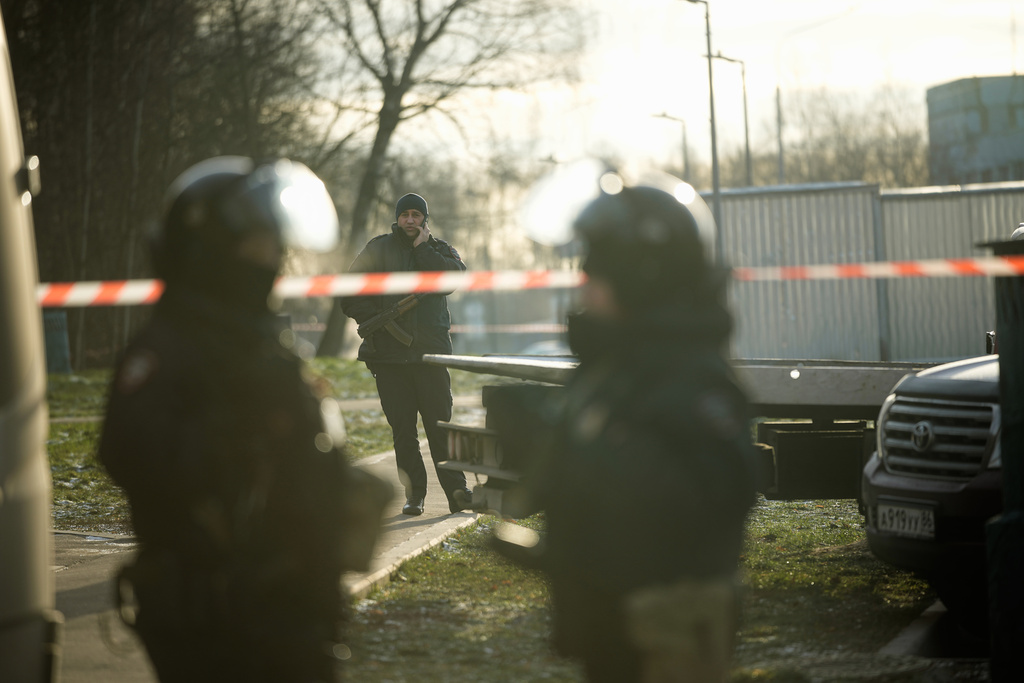 Police block the road near the scene of a deadly explosion in Moscow, Wednesday, Dec. 24, 2025. (AP Photo/Pavel Bednyakov)
