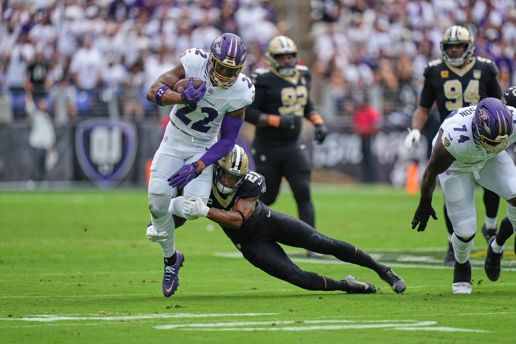 Baltimore Ravens running back Derrick Henry (22) carries against New Orleans Saints safety Justin Reid (21) in the first half of an NFL football game in Baltimore, Sunday, Sept. 20, 2026. (AP Photo/Stephanie Scarbrough)