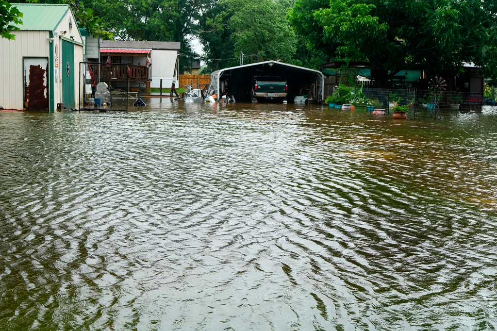 Water surrounds homes in the aftermath of Tropical Storm Arthur in rural Brazoria County, Texas, Wednesday, June 17, 2026. (Brett Coomer/Houston Chronicle via AP)