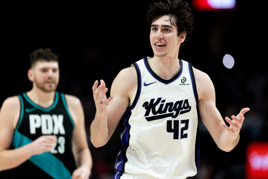 Sacramento Kings center Maxime Raynaud, right, reacts to the foul call during the second half of an NBA basketball game against the Portland Trail Blazers Thursday Dec. 18, 2025, in Portland, Ore. (AP Photo/Howard Lao)