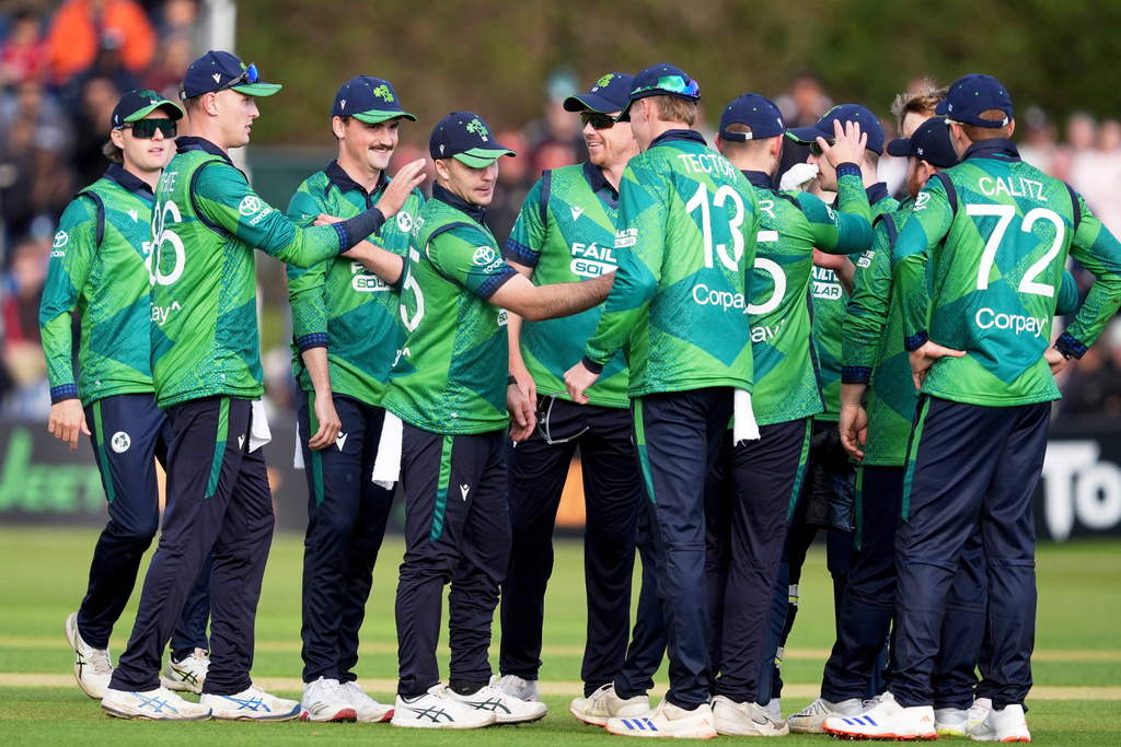 Ireland's Curtis Campher, 4th left, is congratulated by his teammates after catching out England's Jos Buttler during the third men's International Twenty20 cricket match at Malahide Cricket Club in Dublin, Ireland, Sunday Sept. 21, 2025. (Brian Lawless/PA via AP)