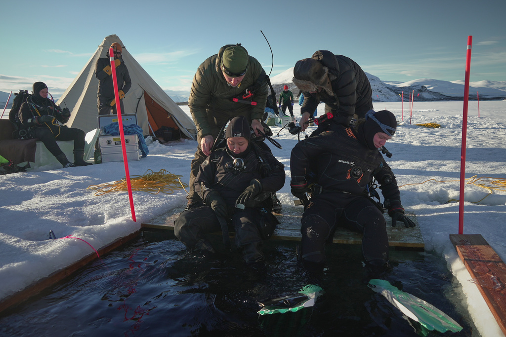 Ruari Buijs, a marine biology and oceanography student, right, and Caroline Chen, a scientific diver and research assistant, prepare to dive during a Polar Scientific Diving class in Kilpisjärvi, March 15, 2026. (AP Photo/Kostya Manenkov)