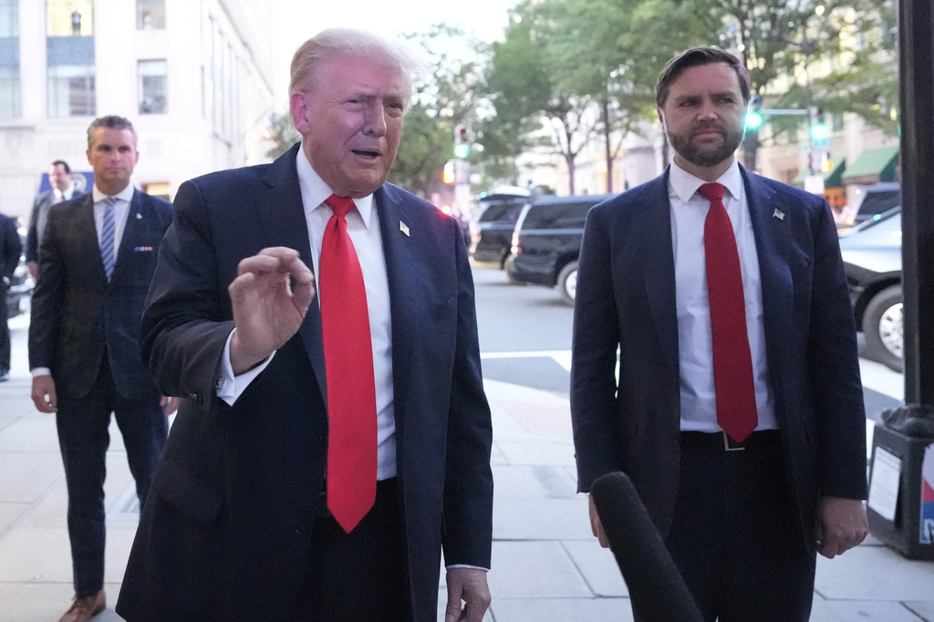 President Donald Trump talks to reporters as he arrives for dinner at a restaurant near the White House, Tuesday, Sept. 9, 2025, in Washington, with Vice President JD Vance. (AP Photo/Alex Brandon)