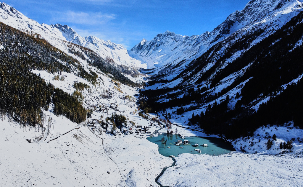 An aerial view shows the partly flooded village of Blatten after recent snowfalls, five months after a landslide destroyed the village, Blatten, Switzerland, on Tuesday, Oct. 28, 2025. (AP Photo/Michael Probst)
