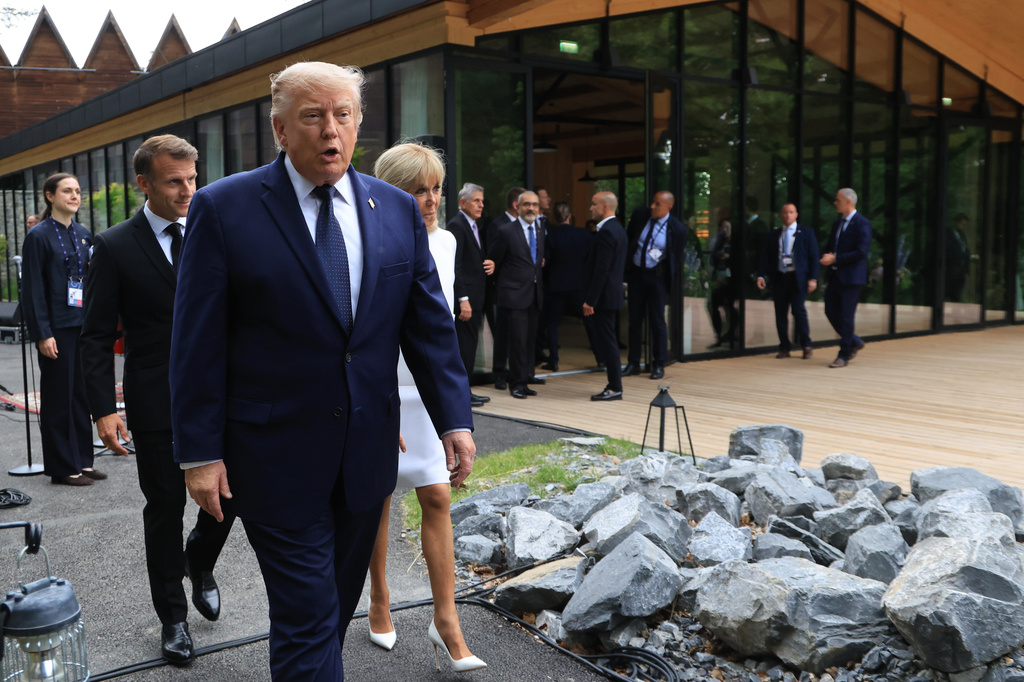 U.S. President Donald Trump walks after posing for a family photo photograph during a gala dinner as part of the G7 summit, in Evian-les-Bains, France, Tuesday June 16, 2026. (Ludovic Marin/Pool Photo via AP)