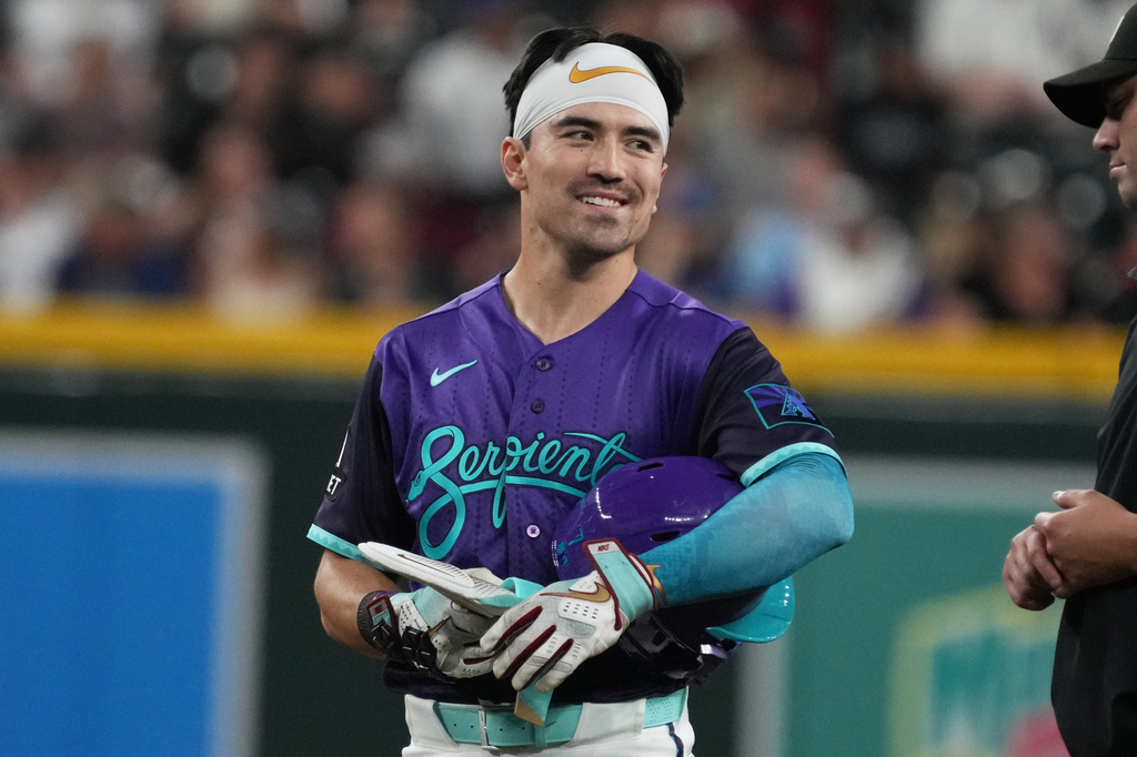 Arizona Diamondbacks' Corbin Carroll, left, reacts after hitting a double against the Minnesota Twins in the fifth inning of a baseball game, Friday, June 19, 2026, in Phoenix. (AP Photo/Rick Scuteri)