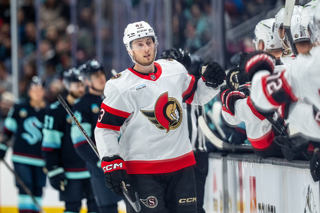 Ottawa Senators defenseman Tyler Kleven celebrates with teammates on the bench after a goal during the first period of an NHL hockey game against the Seattle Kraken, Saturday, March 7, 2026, in Seattle. (AP Photo/Stephen Brashear)