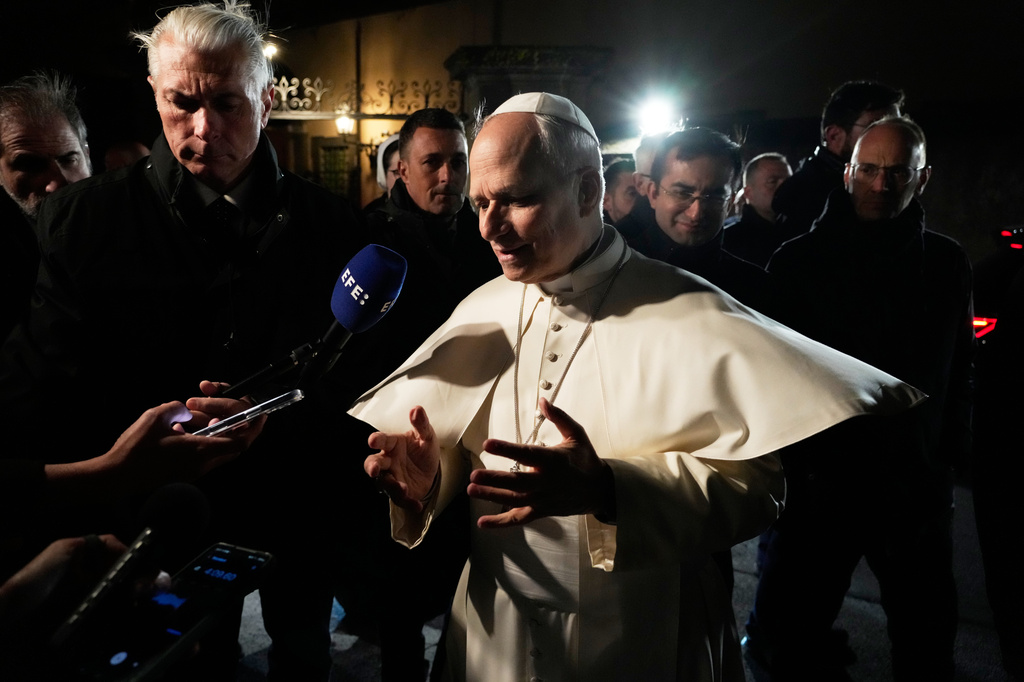 Pope Leo XIV talks to journalists as he leaves his residence in Castel Gandolfo, on the outskirts of Rome, to return to the Vatican, Tuesday, March 31, 2026. (AP Photo/Gregorio Borgia)
