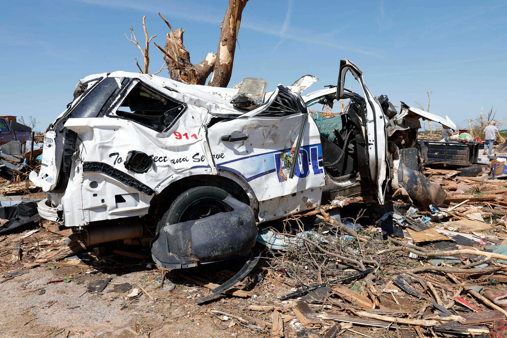 An Enid Police vehicle sits damaged Friday, April 24, 2026, in the Grayridge neighborhood that was damaged by a tornado Thursday in Enid, Okla. (AP Photo/Alonzo Adams)
