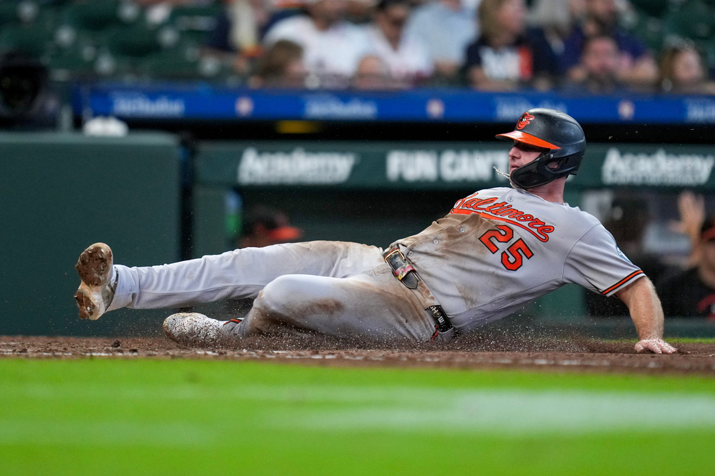 Baltimore Orioles' Pete Alonso slides to score on a two-run single hit by Leody Taveras during the fifth inning of a baseball game against the Houston Astros, Sunday, July 19, 2026, in Houston. (AP Photo/Eric Christian Smith)