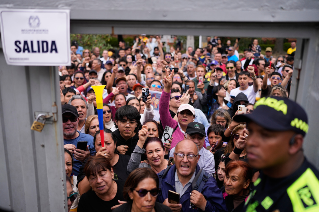 Supporters of presidential candidate Ivan Cepeda of the ruling Historic Pact coalition gather outside the polling station where he voted during the presidential election in Bogota, Colombia, Sunday, May 31, 2026. (AP Photo/Matias Delacroix)