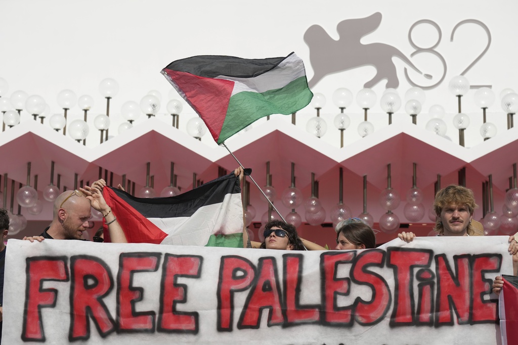 Pro Palestine demonstrators hold a press conference in front of the red carpet to announce a demonstration on Saturday, Aug. 30 during the 82nd edition of the Venice Film Festival in Venice, Italy, on Wednesday, Aug. 27, 2025. (Photo by Alessandra Tarantino/Invision/AP)