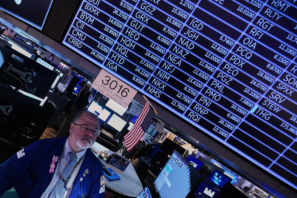Specialist Douglas Johnson works at his post on the floor of the New York Stock Exchange, Thursday, Jan. 22, 2026. (AP Photo/Richard Drew)