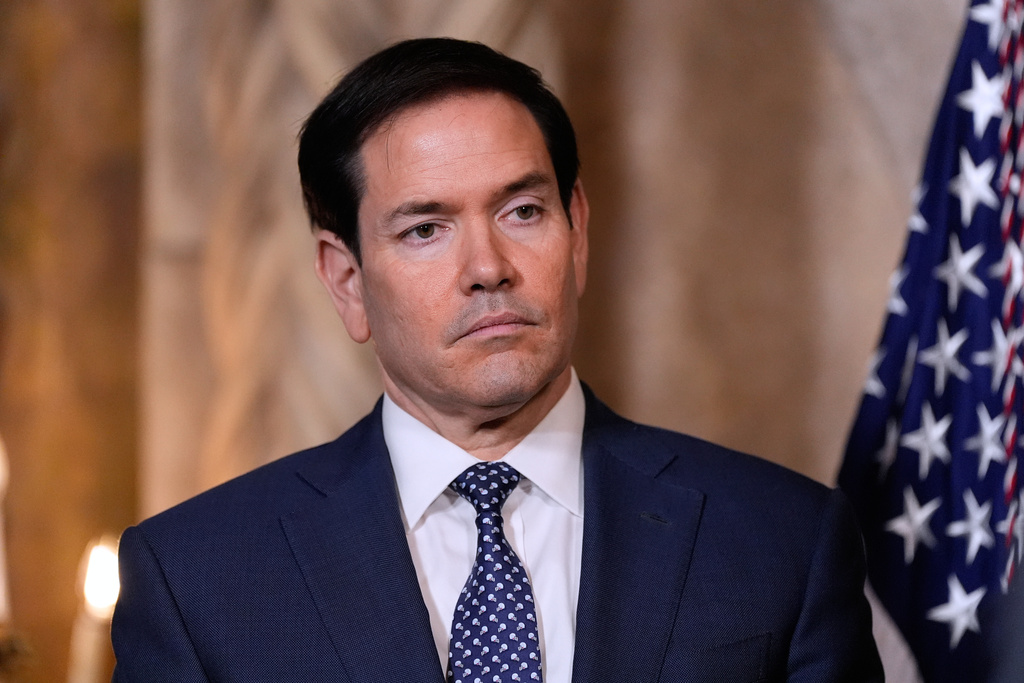 Secretary of State Marco Rubio listens as President Donald Trump speaks at his Mar-a-Lago club, Monday, Dec. 22, 2025, in Palm Beach, Fla. (AP Photo/Alex Brandon)
