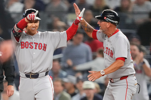 Boston Red Sox outfielder Masataka Yoshida, left, celebrates with first base coach José David Flores after driving in two runs against the New York Yankees during the seventh inning of Game 1 of an American League wild-card baseball playoff series, Tuesday, Sept. 30, 2025, in New York. (AP Photo/Yuki Iwamura) Boston Red Sox outfielder Masataka Yoshida, left, celebrates with first base coach José David Flores after driving in two runs against the New York Yankees during the seventh inning of Game 1 of an American League wild-card baseball playoff series, Tuesday, Sept. 30, 2025, in New York. (AP Photo/Yuki Iwamura)