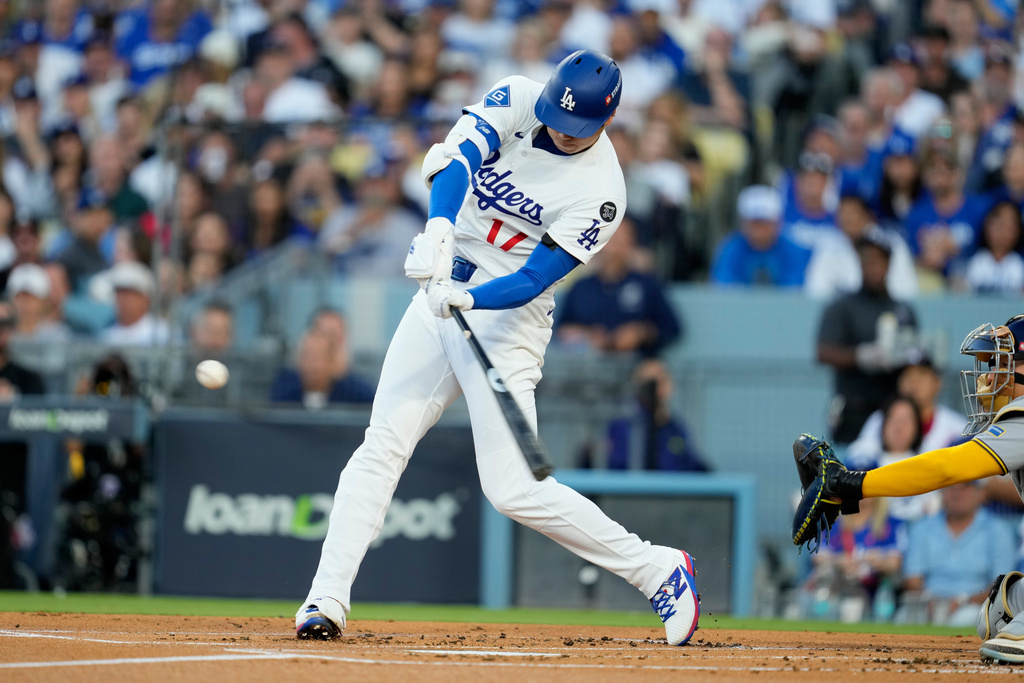 Los Angeles Dodgers' Shohei Ohtani hits a home run against the Milwaukee Brewers during the first inning in Game 4 of baseball's National League Championship Series, Friday, Oct. 17, 2025, in Los Angeles. (AP Photo/Ashley Landis)