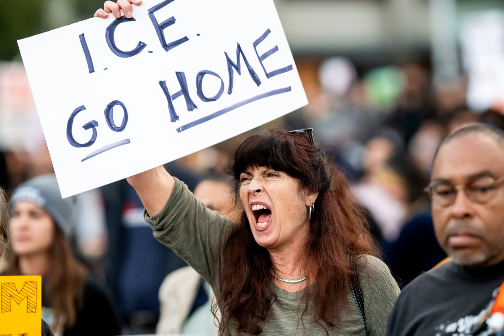 Heather Davison protests against immigration raids in San Francisco on Thursday, Oct. 23, 2025. (AP Photo/Noah Berger)