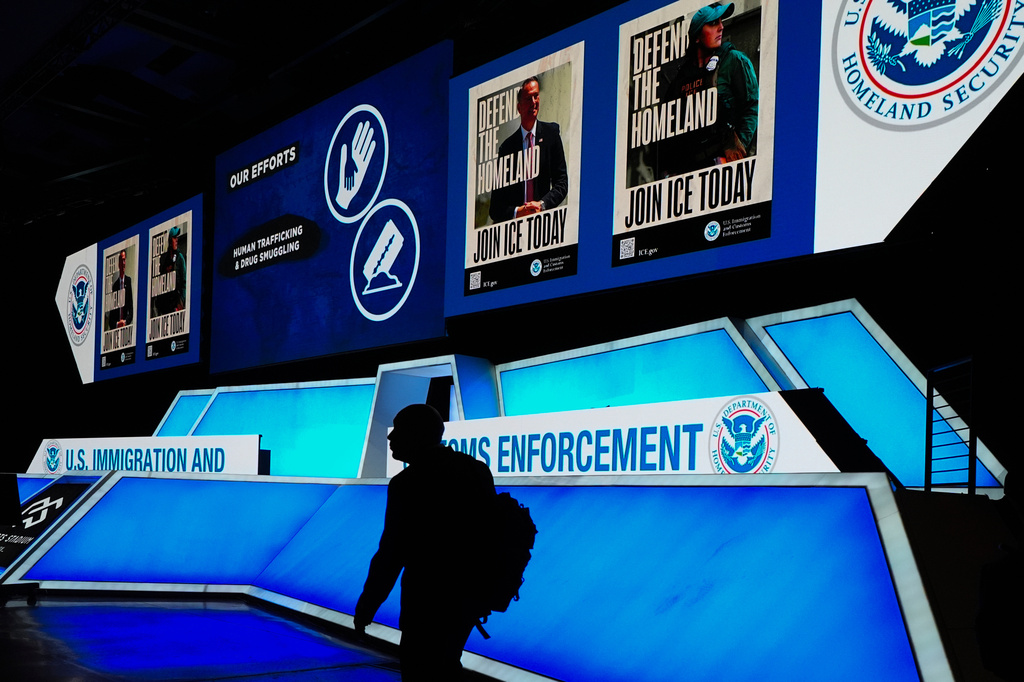 FILE - A person walks near the stage during an Immigration and Customs Enforcement (ICE) hiring fair in Arlington, Texas, on Tuesday, Aug. 26, 2025. (AP Photo/Julio Cortez, File)
