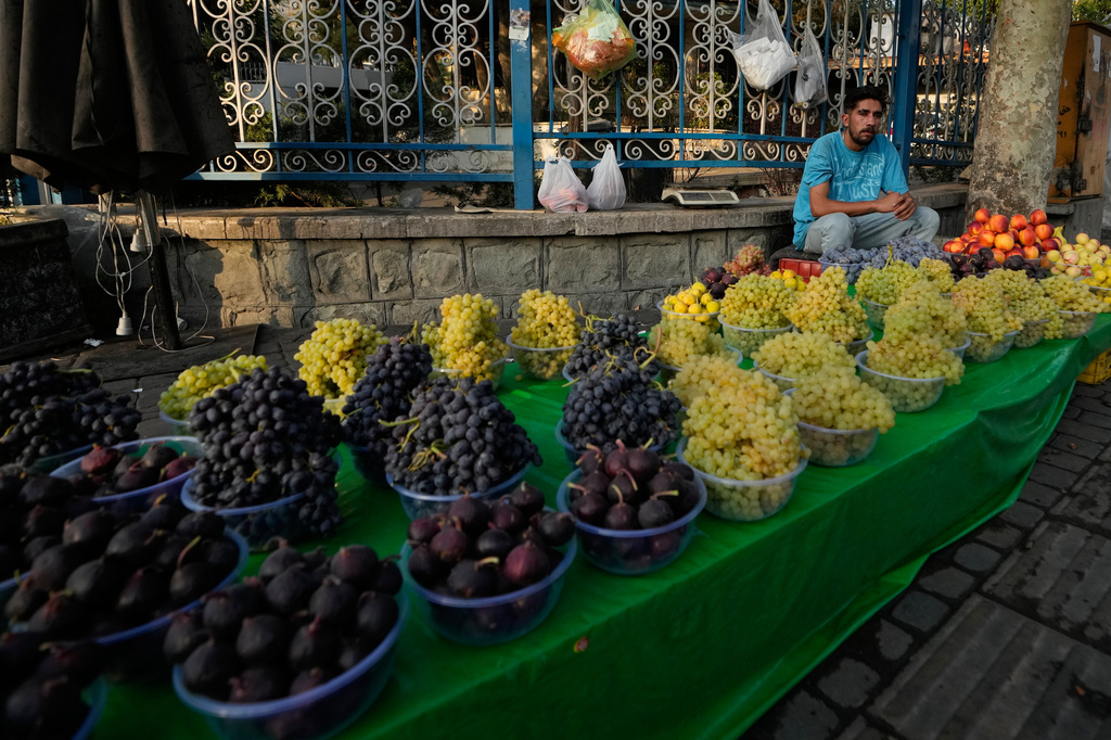 A fruit seller waits for customers at the Tajrish square in northern Tehran, Iran, Saturday, Sept. 12, 2026. (AP Photo/Vahid Salemi)