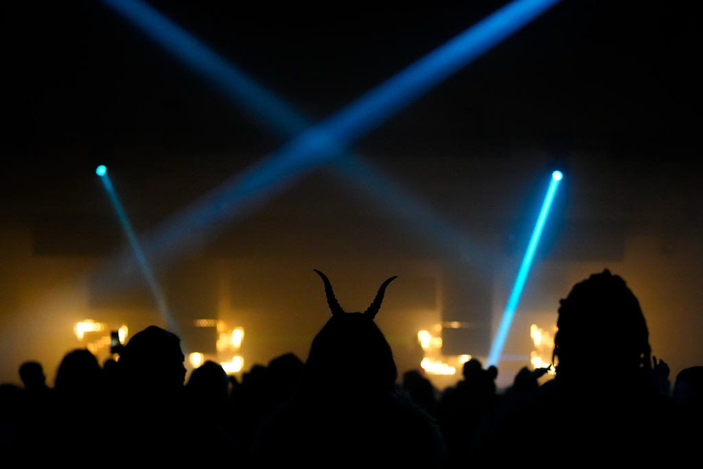 A woman wearing devil horns attends a Halloween rave in Kyiv, Ukraine, Saturday, Oct. 25, 2025. (AP Photo/Julia Demaree Nikhinson)