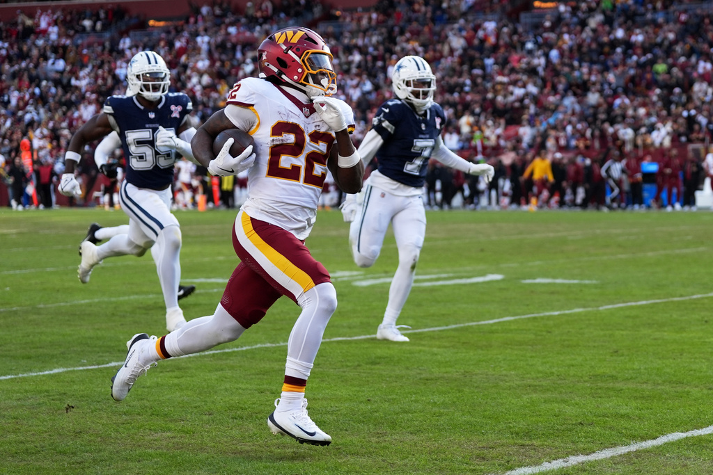 Washington Commanders running back Jacory Croskey-Merritt (22) scores on a touchdown run during the second half an NFL football game against the Dallas Cowboys Thursday, Dec. 25, 2025, in Landover, Md. (AP Photo/Stephanie Scarbrough)