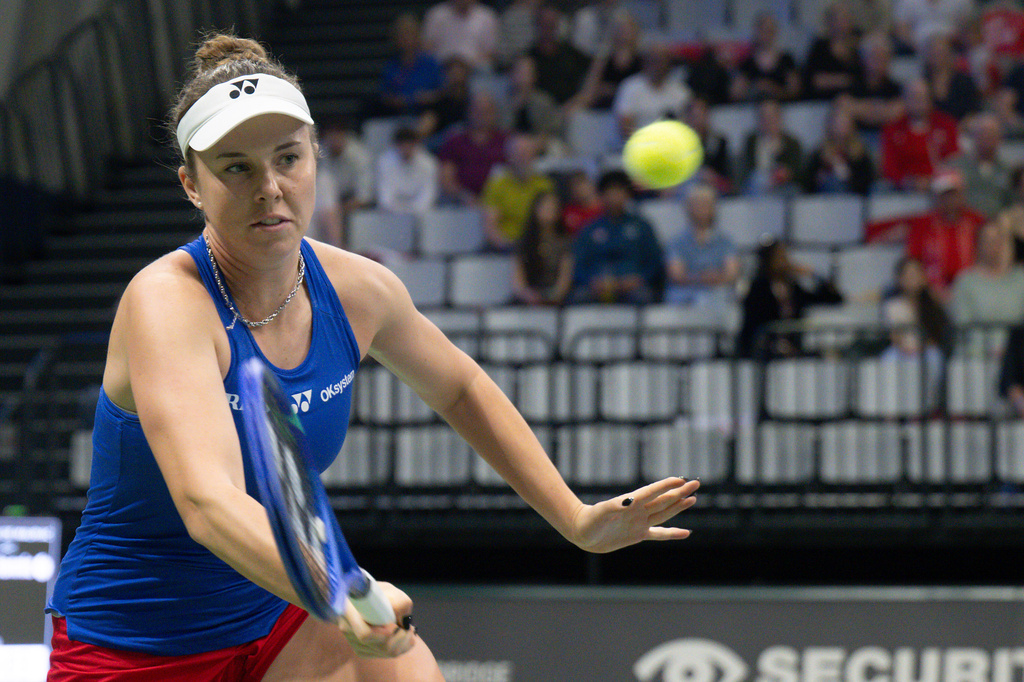 Czech Republic's Linda Noskova returns the ball to Switzerland's Belinda Bencic during the tennis Billie Jean King Cup qualifiers round between Switzerland and Czech Republic at the Swiss Tennis Arena in Biel, Switzerland, on Saturday April 11, 2026. (Peter Schneider/Keystone via AP)
