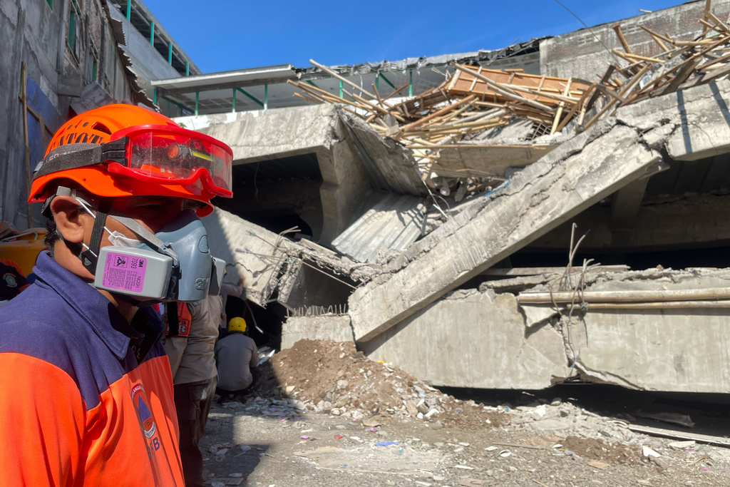 Rescuers search for victims after a building under construction collapsed, at an Islamic boarding school in Sidoarjo, East Java, Indonesia, Wednesday, Oct. 1, 2025. (AP Photo/Trisnadi)