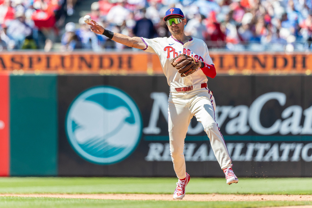 Philadelphia Phillies shortstop Trea Turner throws to first base for an out against Arizona Diamondbacks' Nolan Arenado in the first inning of a baseball game, Sunday, April 12, 2026, in Philadelphia. (AP Photo/Laurence Kesterson)