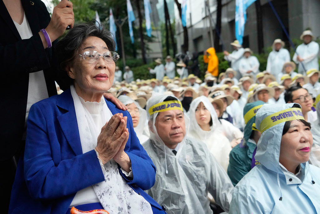 FILE - Former comfort woman, Lee Yong-soo, left, who was forced to serve for the Japanese troops as a sex slave during World War II, attends a rally demanding full compensation and an apology for wartime sex slaves from Japanese government near the Japanese Embassy in Seoul, South Korea, on Aug. 13, 2025. (AP Photo/Ahn Young-joon, File)
