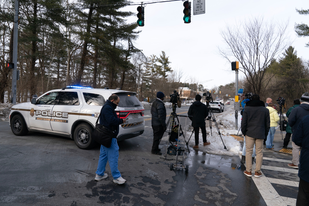 Montgomery County Police block the street as people wait outside Thomas S. Wootton High School for students in Rockville Md., Monday, Feb. 9, 2026, after a person was shot inside the school. (AP Photo/Jose Luis Magana)