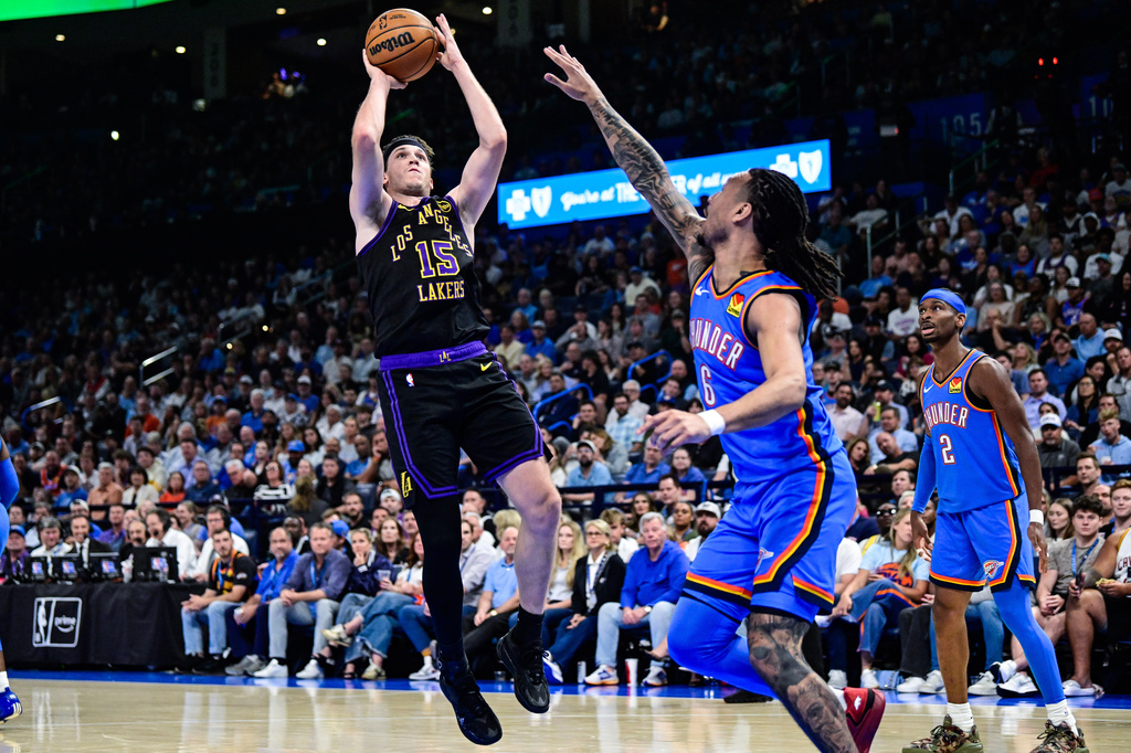 Los Angeles Lakers guard Austin Reaves (15) shoots against Oklahoma City Thunder forward Jaylin Williams (6) during the first half of an NBA basketball game Thursday, April. 2, 2026, in Oklahoma City. (AP Photo/Gerald Leong)