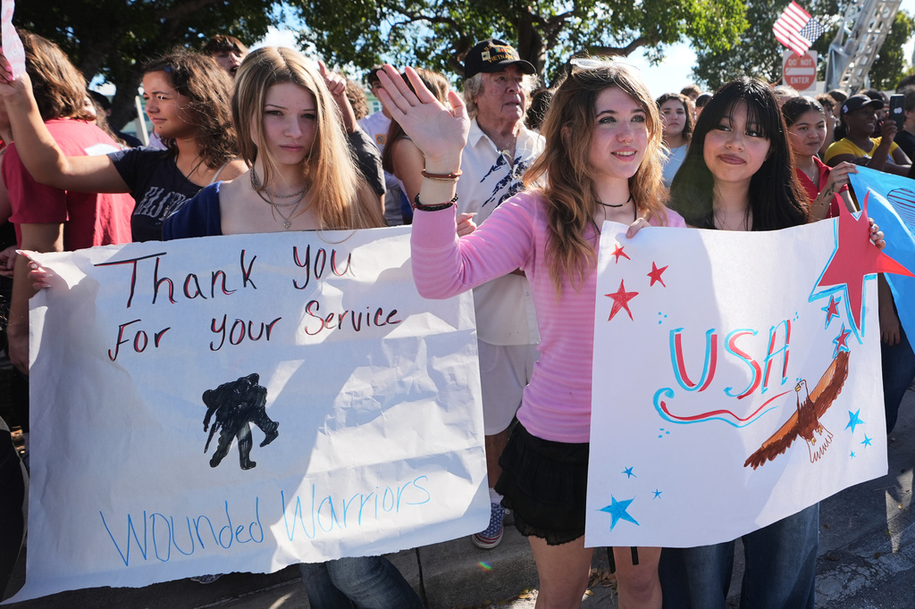 Students from the Coral Shores High School wave as wounded veterans ride past in the annual Florida Keys Soldier Ride organized by the Wounded Warrior Project, Friday, Jan. 9, 2026, in Islamorada, Fla. (AP Photo/Lynne Sladky)