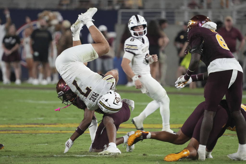 Arizona State defensive back Myles Rowser upends Texas State running back Lincoln Pare (7) in the second half of an NCAA college football game, Saturday, Sept. 13, 2025, in Tempe, Ariz. (AP Photo/Rick Scuteri)