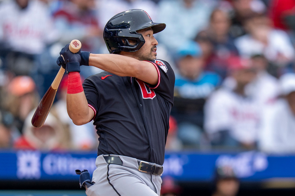 Cleveland Guardians' Steven Kwan hits a single to score Daniel Schneemann during the fifth inning of a baseball game against the Philadelphia Phillies, Sunday, May 24, 2026, in Philadelphia. (AP Photo/Chris Szagola)