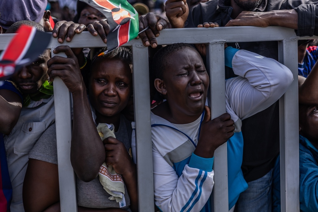 People react during the viewing of the body of former Kenyan Prime Minister Raila Odinga at Jomo Kenyatta Stadium in Kisumu, Kenya, Saturday, Oct. 18, 2025. (AP Photo/Samson Otieno)