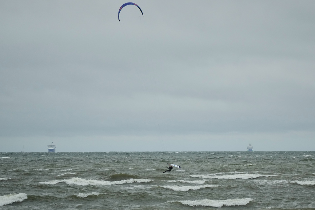 A kitesurfer makes use of strong winds on the Tallinn bay of the Baltic sea on a rainy and windy day in Tallinn, Estonia, Sunday, Aug. 23, 2026. (AP Photo/Sergei Grits)