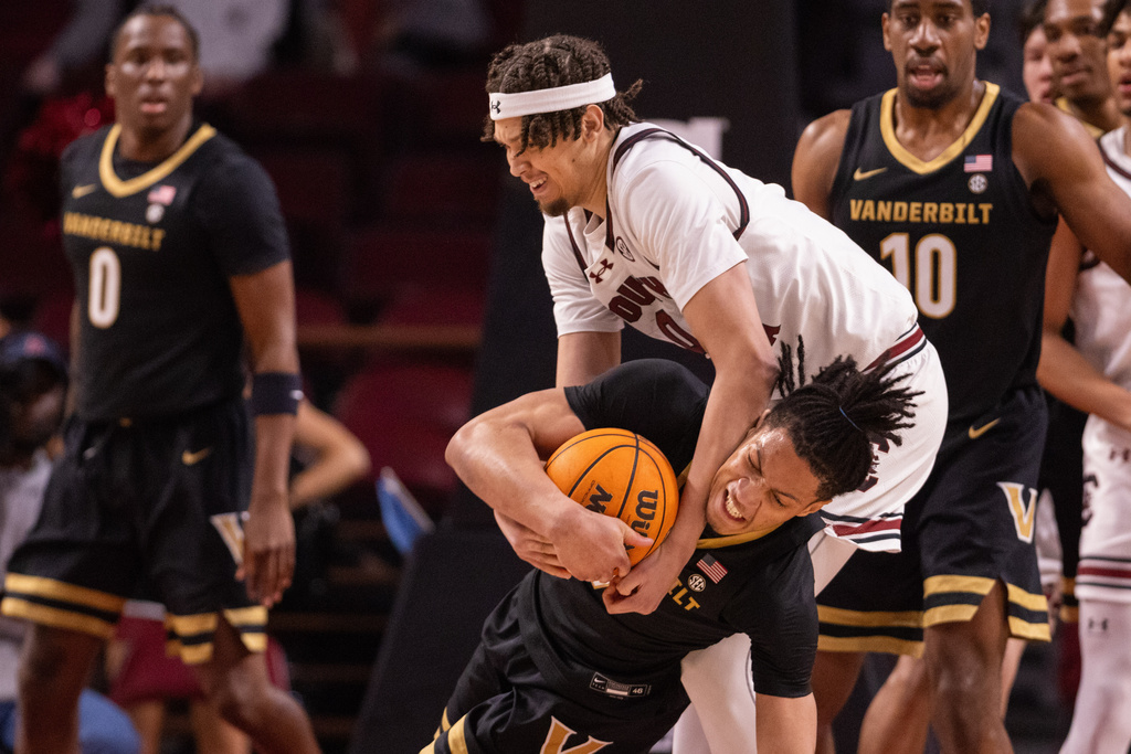 South Carolina forward Jordan Butler (0) and Vanderbilt guard Chandler Bing (7) battle for the ball during the first half of an NCAA college basketball game, Saturday, Jan. 3, 2026, in Columbia, N.C. (AP Photo/Scott Kinser)