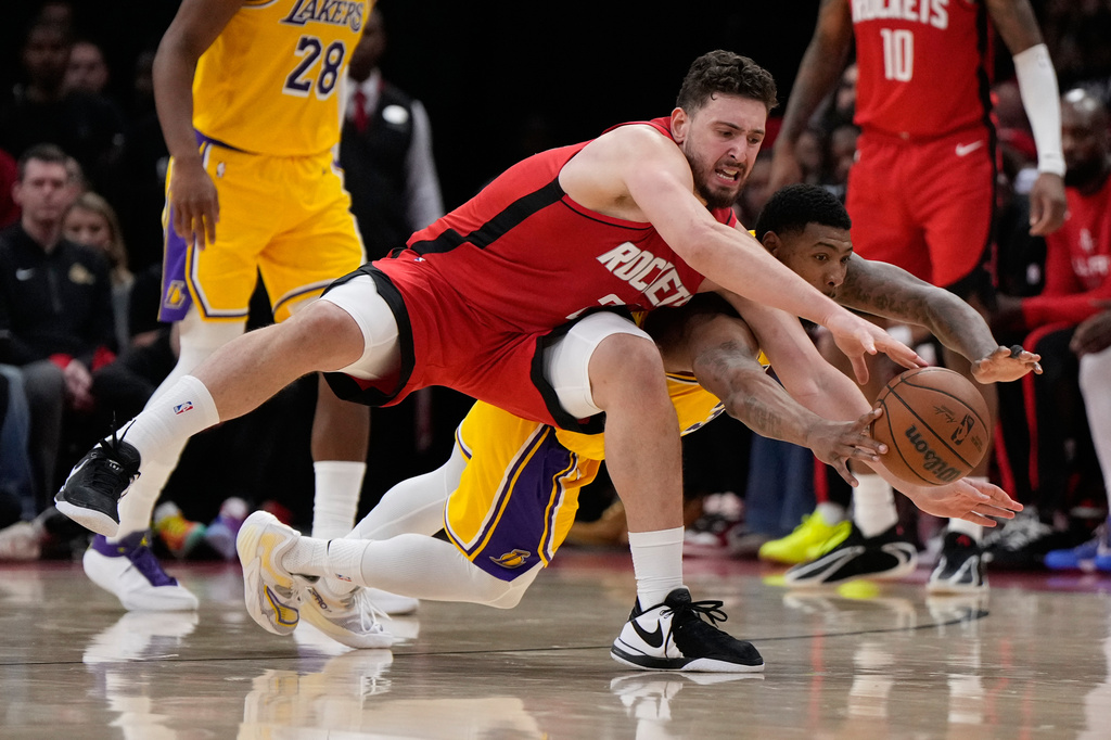 Houston Rockets center Alperen Sengun, left, and Los Angeles Lakers guard Marcus Smart (36) dive for a loose ball during the first half of Game 6 of a first-round NBA playoffs basketball series in Houston, Friday, May 1, 2026. (AP Photo/Ashley Landis)