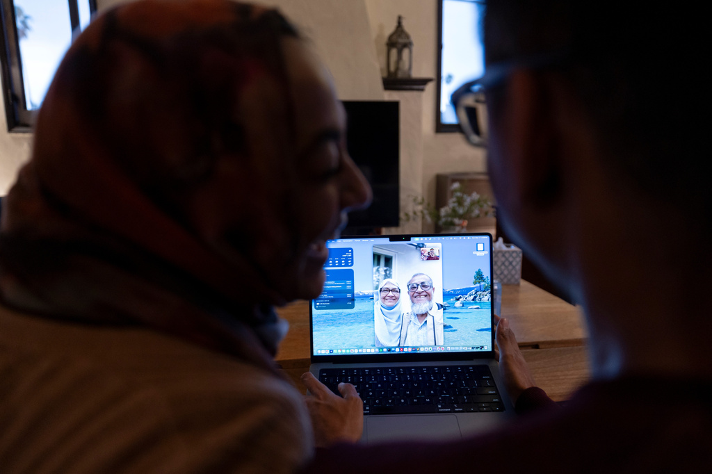 Samiha Matin, left, laughs with her husband Faisal Rashid as they video chat with Samiha Matin's parents, Mohammed and Nasima Matin, Sunday, May 17, 2026, in Pasadena, Calif. (AP Photo/Ryan Sun)