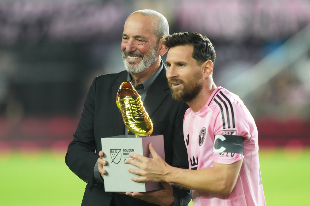 MLS Commissioner Don Garber presents the Golden Boot award to Inter Miami forward Lionel Messi before match one of their MLS playoff opening round soccer match against the Nashville SC, Friday, Oct. 24, 2025, in Fort Lauderdale, Fla. (AP Photo/Marta Lavandier)