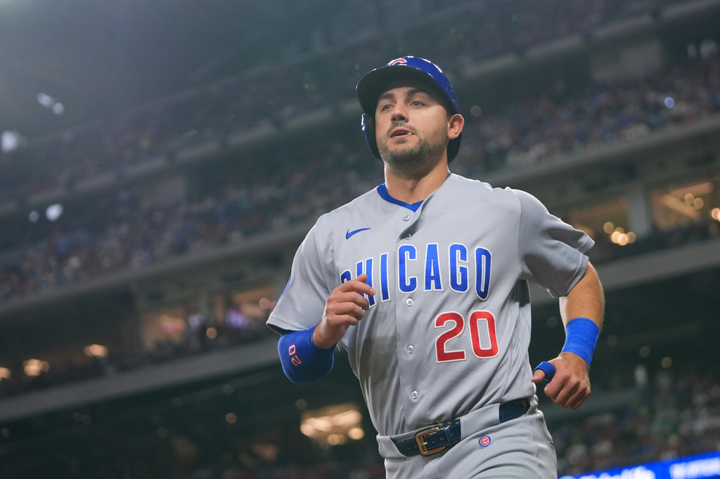 Texas Rangers second baseman Ezequiel Duran scores on a single by teammate Ian Happ during the first inning of a baseball game against the Texas Rangers Friday, May 8, 2026, in Arlington, Texas. (AP Photo/Julio Cortez)