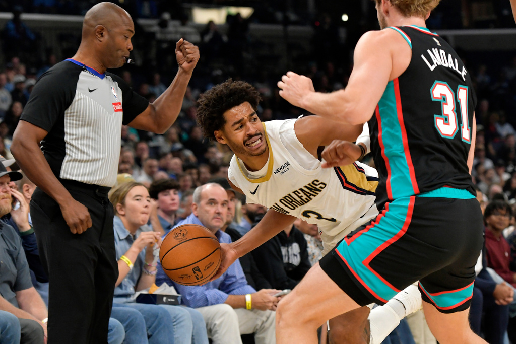 New Orleans Pelicans guard Jordan Poole (3) handles the ball against Memphis Grizzlies center Jock Landale (31) in the first half of an NBA basketball game Wednesday, Oct. 22, 2025, in Memphis, Tenn. (AP Photo/Brandon Dill)
