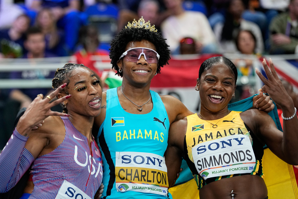 Devynne Charlton, of Bahamas, poses with Alia Armstrong, of the United States, left, and Megan Simmonds, of Jamaica, after winning the gold medal in the women's 60 meters hurdles final at the World Athletics Indoor Championships in Torun, Poland, Sunday, March 22, 2026. (AP Photo/Matthias Schrader)